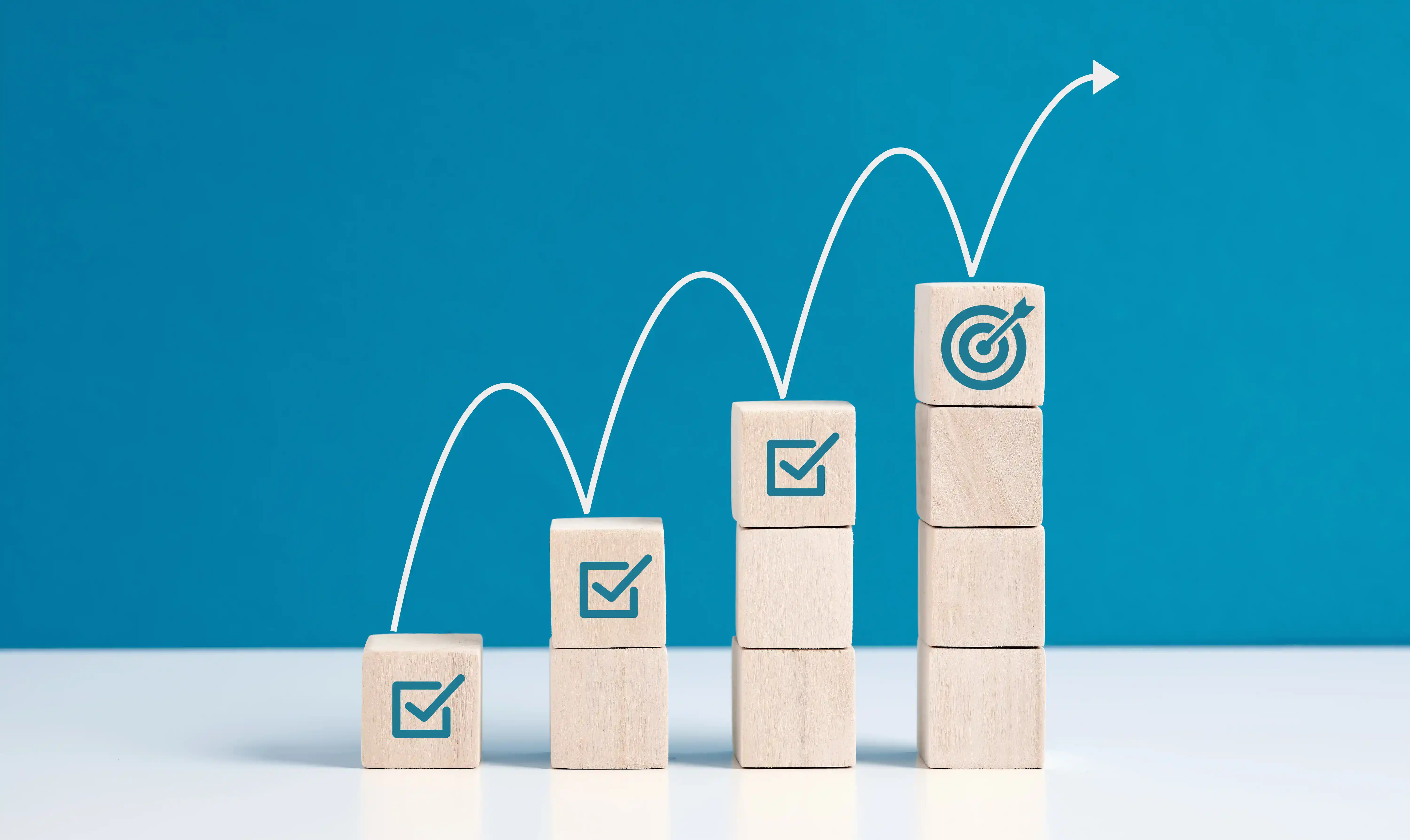 Business growth shown on building blocks with goals being met