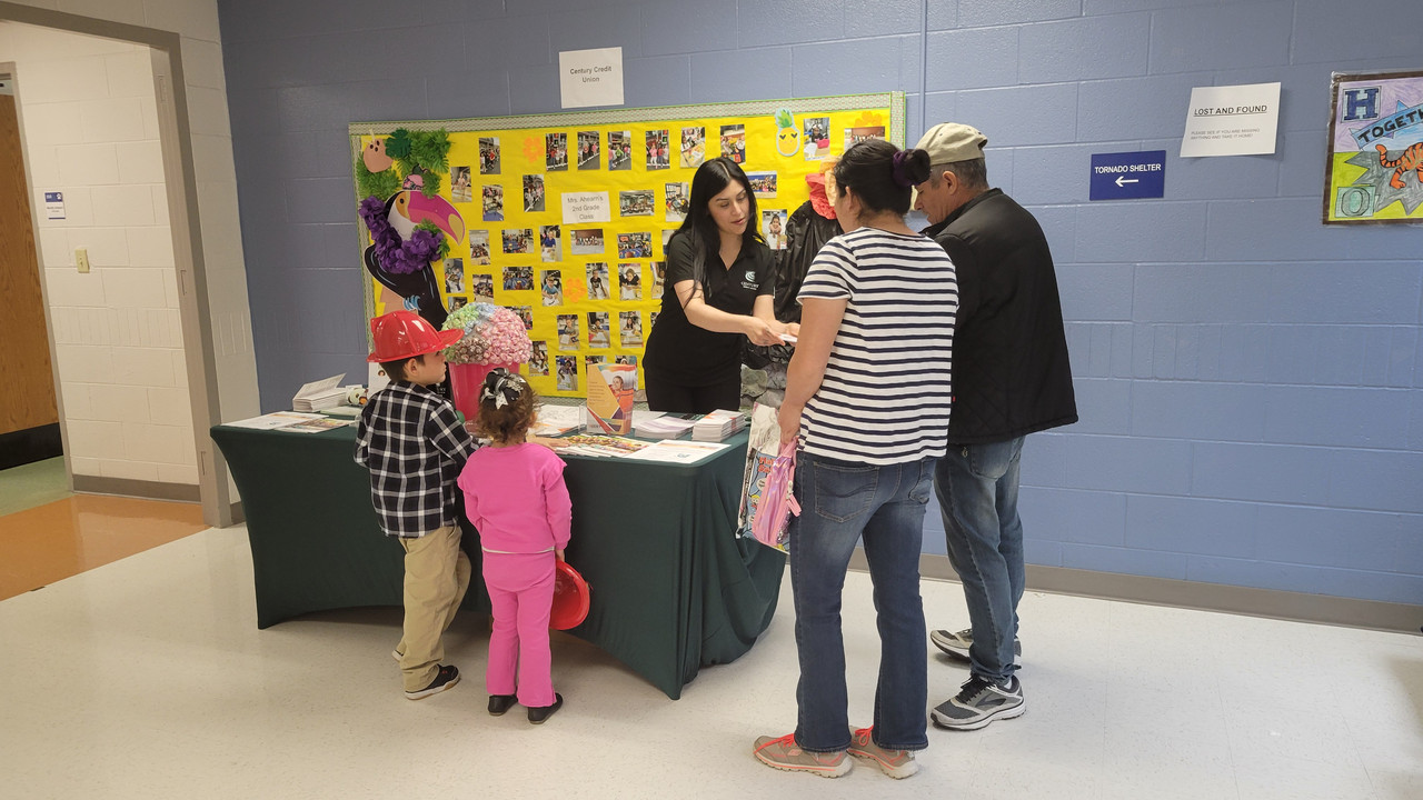 Mayra helping a family at a community event